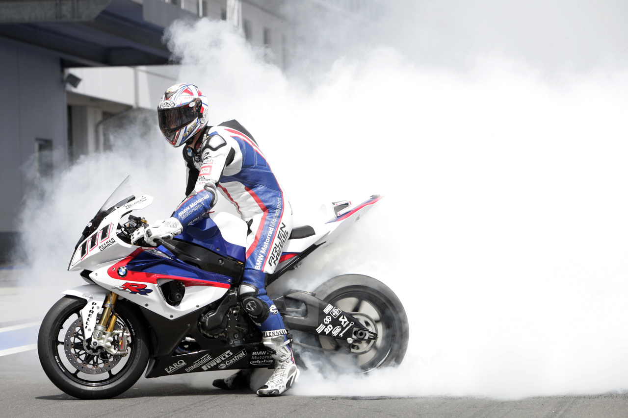 BMW Motorsport 2009 Monday, 20 July 2009, Nurburgring. Germany. BMW Sauber F1 Team Race Club Fan Event. BMW Motorrad Motorsport Rider Ruben Xaus (ESP) makes a burn out on the BMW S 1000 RR. This image is copyright free for editorial use © BMW AG